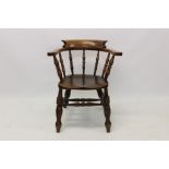 Victorian beech and elm captains chair of typical tub form,