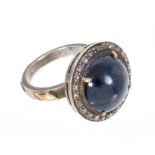 Sapphire and diamond cluster ring, the large blue sapphire cabochon measuring 13.