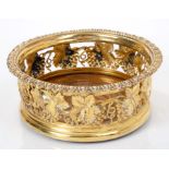 Regency period silver gilt wine coaster with pierced grape and vine decoration and egg and dart