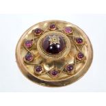 Victorian target brooch, the circular disc set with round cabochon garnets,