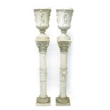 Impressive pair of reconstituted marble urns on pedestals,