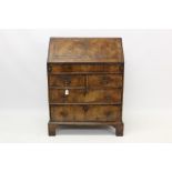 Early 18th century walnut crossbanded and feather-banded bureau of small size,