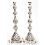 Pair 1920s silver Shabbat candlesticks of typical form, with embossed foliate decoration,