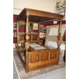 Modern oak four poster bed in the 17th century style with canopy top and fielded panel head and
