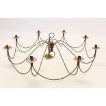 Large wire work chandelier with eight scrolling candle arms,