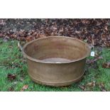 Very large copper vessel, straight sided with surmounting loop handles,