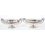 Pair 1920s silver two-handled bonbon dishes of oval form, with fluted panels and pierced borders,
