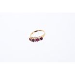 Ruby and diamond ring with four oval mixed cut rubies interspaced by six brilliant cut diamonds in