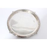 Early George V silver salver of circular form, with leaf-mounted flared border (London 1912),