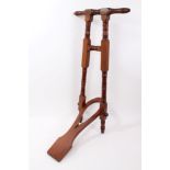 Edwardian mahogany folding boot jack with ring turned supports,