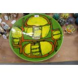 Poole Pottery circular charger with abstract decoration on green, orange and yellow ground,