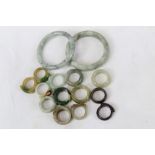 Collection of Chinese jade or green hardstone bangles and rings (approximately 15)