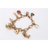 Gold (9ct) charm bracelet set with eight assorted charms and padlock clasp CONDITION