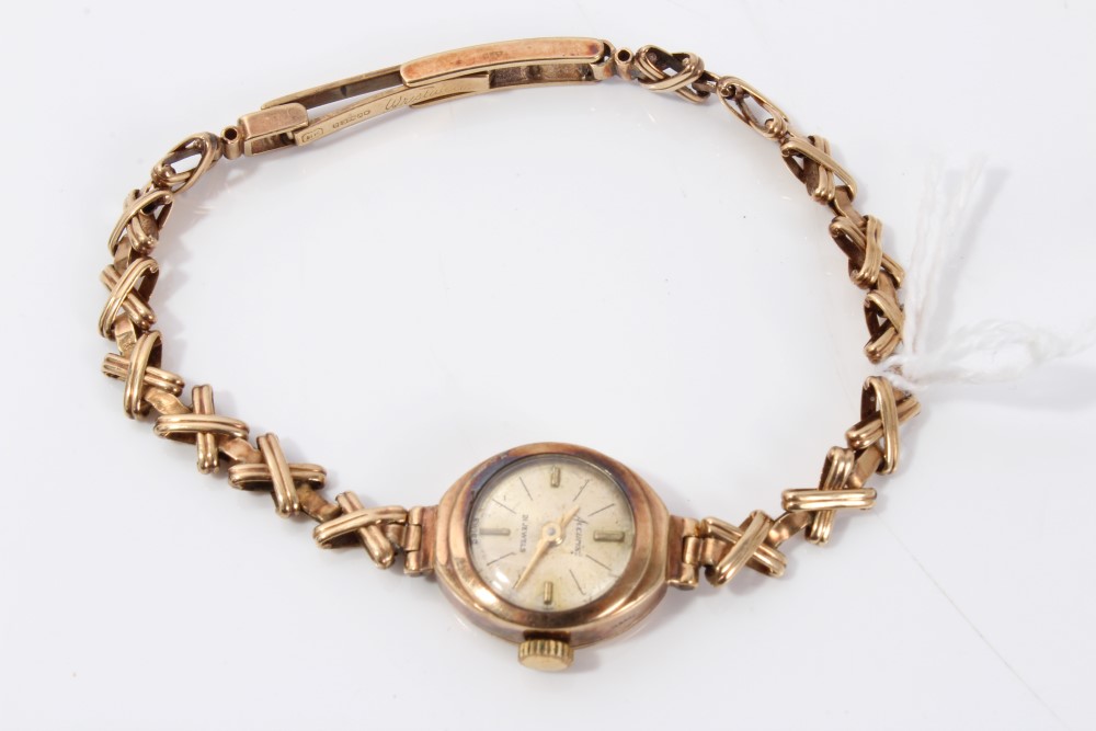 Ladies' gold (9ct) Accurist mechanical wristwatch on gold (9ct) cross design link bracelet