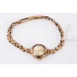 Ladies' gold (9ct) Accurist mechanical wristwatch on gold (9ct) cross design link bracelet