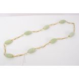 Chinese necklace formed of green carved hardstone beads,