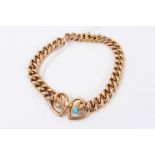 Edwardian 15ct gold curb link bracelet with two entwined hearts,
