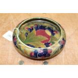 First World War period William Moorcroft Pomegranate pattern shallow circular bowl on green ground