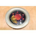 Moorcroft Pomegranate pattern circular dish with hammered pewter rim, 14.