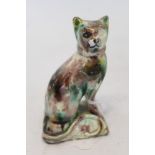 18th century English agate glazed figure of a seated cat with tail curled to front, on cushion,