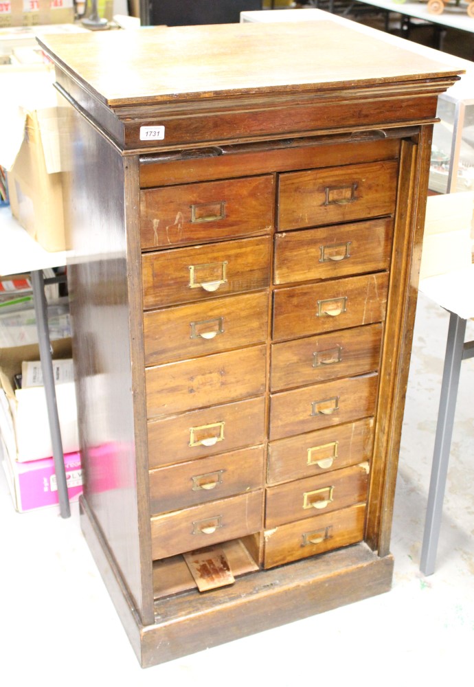 Early 20th century oak haberdashery cabinet with eighteen drawers and tambour shutter