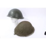 Two British Military MK III pattern steel helmets, one with camouflage netting (2)