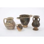 Etruscan black glazed pottery urn, together with three other glazed Ancient Italian vessels.