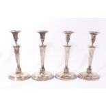 Set of four early 19th century silver plated candlesticks with fluted tapering stems