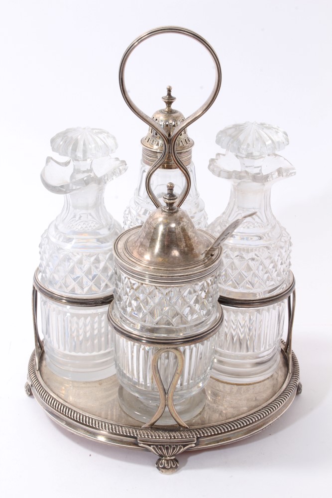 George III silver cruet frame with four lidded cut glass condiment bottles, William Bateman 1819