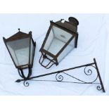Antique painted metal street lamp, tapered form with glazed sides projecting on scrolling bracket,