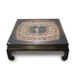 Large Chinese low table with relief carved inset pierced concentric panel on ebonised scroll legs