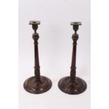 Pair of George III mahogany and brass mounted candlesticks