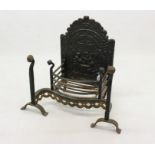 Antique fire back with shaped brass front to grate