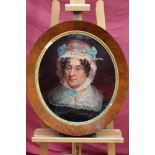 19th century English school oval oil on canvas laid on board - portrait of a lady wearing a bonnet,