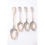 George III silver fiddle pattern basting spoon and three similar tablespoons