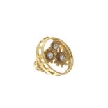 18ct gold oval openwork ring with three flowers, each set with a brilliant cut diamond