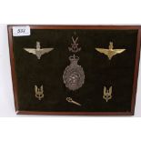 Group of Special Forces cap badges, including SAS mounted on a board (7 badges)