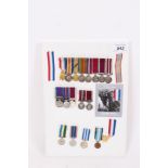 Collection of various miniature medals, mounted on board, together with a Ministry of Defence