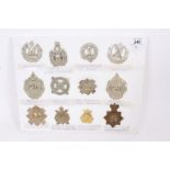 Group of twelve British military cap badges including Victorian 14th Lancashire Rifle Volunteers