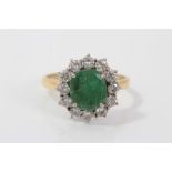 Gold (18ct) emerald and diamond cluster ring with an oval emerald surrounded by twelve brilliant