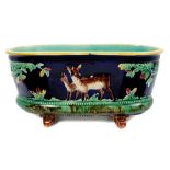 Victorian Majolica planter of oval form, with deer and tree decoration, raised on scroll feet