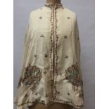 Victorian fine cream wool cape with embroidered floral motifs and running floral border. Lined with