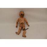 19th century carved wooden painted doll, eyes missing, with ball jointed limbs.