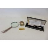 Silver handled magnifying glass, together with a silver fountain pen, a silver napkin ring and a