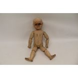 19th century carved wooden painted doll with blue inset eyes and ball jointed limbs