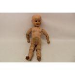 19th century carved wooden painted doll with inset blue glass eyes and ball jointed limbs