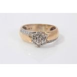 Gold (9ct) diamond flower head cluster ring with further diamonds set to either side of the thick