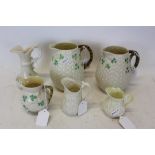 Group of six Belleek porcelain jugs