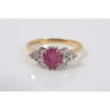 18ct gold diamond and pink stone ring with an oval cut pink tourmaline/ruby flanked by six