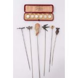 Six novelty hatpins including ivory skull and female head and cased set of mother o' pearl dress